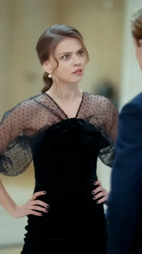 Black velvet dress with sheer polka-dot tulle sleeves, in Rushed into Love: The Pregnant Heiress