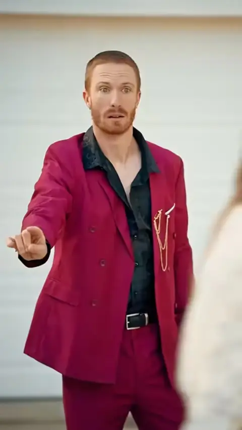 Magenta double-breasted suit with a black paisley shirt, in My Mechanic Husband Is a Hidden Billionaire