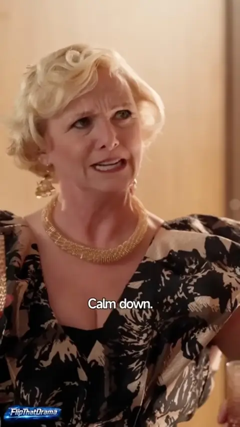 Black and beige print blouse with gold collar necklace, in The Mafia King at His Wife's Wedding