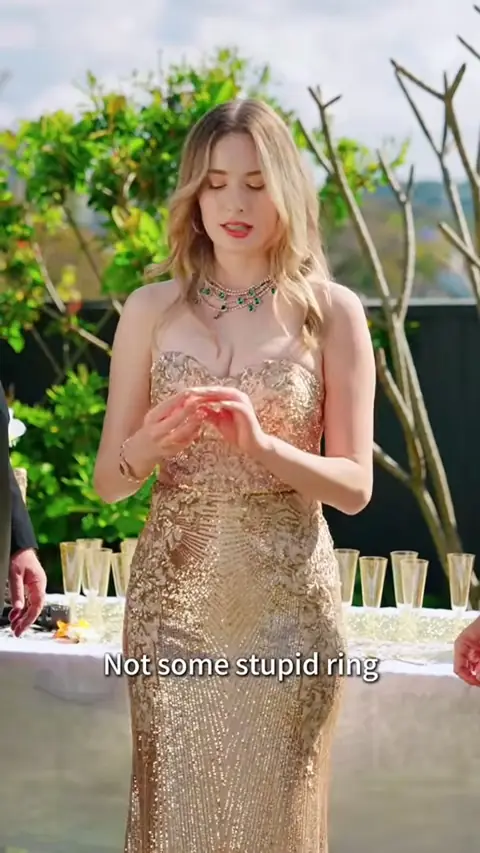 Gold sequin strapless gown and an emerald necklace, in Billionaire Heiress Went Undercover as a Cleaner