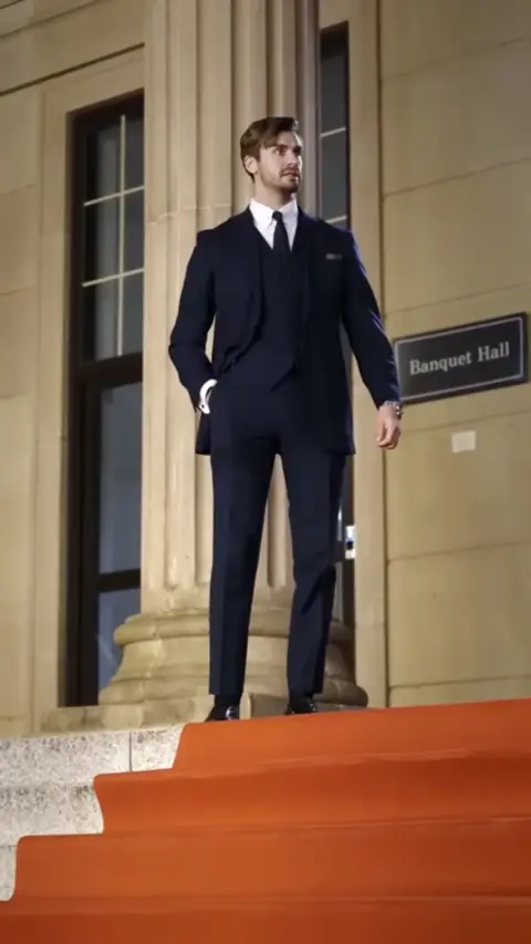 Navy three-piece suit with a dark tie, still at 17:25 in Ordinary Cleaner Turns Into a Beauty and Shocks Everyone