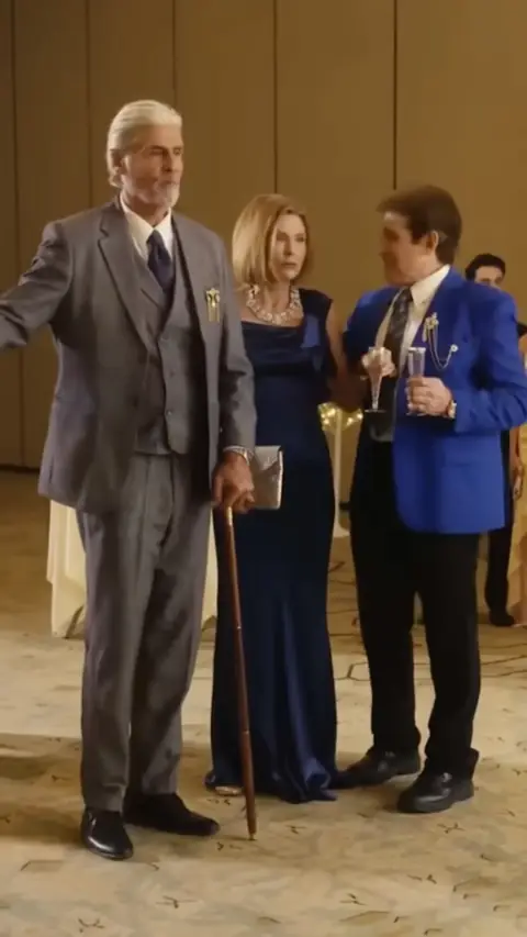 Grey three-piece suit and a navy satin gown, in From Lost Heiress to Mafia Queen
