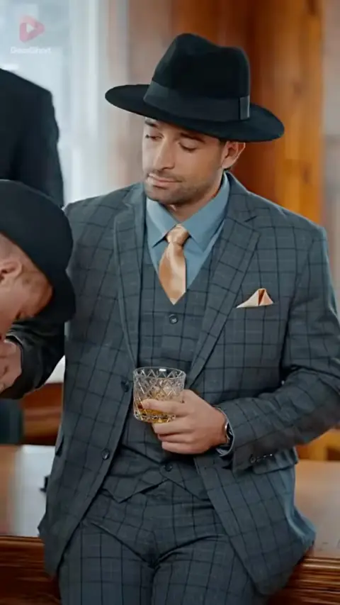 Grey windowpane three-piece suit with a black fedora, still at 1:27:02 in The Ruthless Mafia Heir Never Loved Anyone, Until He Met Me
