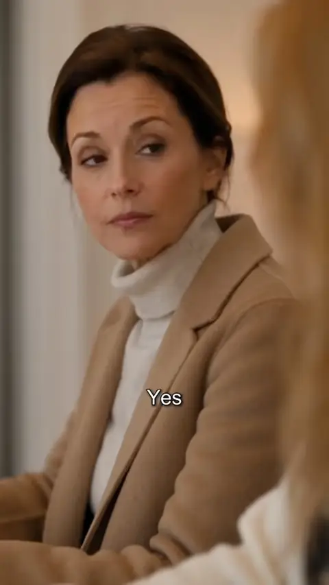 Camel wool coat over a white turtleneck, still at 47:36 in I Dated a Billionaire Online With a Fake Photo