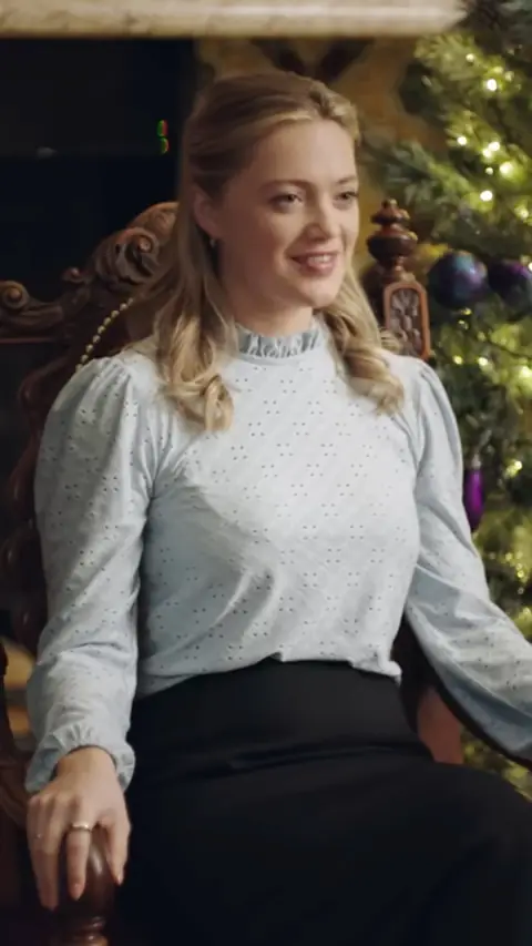 Pale blue eyelet blouse and black skirt, in My Very Royal Romance