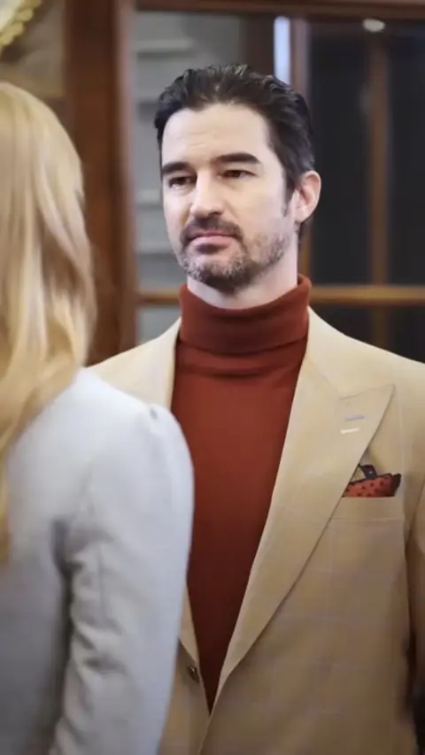 Camel peak-lapel blazer over a rust turtleneck, in Ordinary Cleaner Turns Into a Beauty and Shocks Everyone